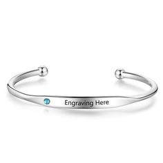 The Personalized Birthstone & Name Bangle Bracelet in Stainless Steel is a fusion of simplicity and elegance. Its sleek and smooth surface is the perfect setting for a personalized engraving and is adorned with a single, sparkling birthstone of your choice. This minimalist design makes it a versatile piece that can be worn daily, subtly celebrating someone special or a meaningful moment. As a Mother’s Day gift, this bangle offers an understated yet poignant gesture, allowing every mother to carry a touch of her loved one’s essence with her at all times. High-Quality Craftsmanship: Our dedication to excellence shines through in the meticulous crafting of this bracelet. Utilizing high-grade Stainless Steel, we ensure that each piece retains its luster over time, standing up to daily wear whi Personalized Stainless Steel Elegant Bangle, Elegant Personalized Name Bracelet With Birthstone, Mother's Day Engraved Stainless Steel Name Bracelet, Personalized Adjustable Bangle For Mother's Day, Nickel-free Bangle Charm Bracelet For Personalized Gift, A Mother, Stainless Steel Bracelet, Bangle Bracelet, High Grade