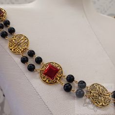 The "Daniel" Jeweled Renaissance Collar of Office exudes sophistication and elegance with its Tibetan-style connectors and 15mm brilliant acrylic gems delicately set in lacy settings. Adorn yourself in this exquisite piece crafted for royalty, perfect for occasions of grandeur and royal regalia. See main menu for other sizes available. Unless you request otherwise, all jeweled collars with flat-back settings will include support pins that are affixed to settings positioned in the shoulder areas Gold Round Beads Evening Jewelry, Gold Jewelry With Gemstone Accents For Evening, Elegant Adjustable Filigree Necklace, Elegant Jeweled Round Beads Jewelry, Elegant Jeweled Round Bead Necklaces, Elegant Jeweled Necklaces With Round Beads, Elegant Metal Necklaces With Decorative Details, Adjustable Formal Jewelry With Gemstone Accents, Gold Fusion Evening Jewelry