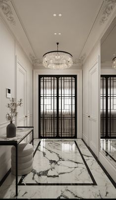 an elegant hallway with marble flooring and chandelier