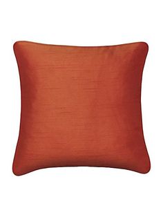 an orange pillow on a white background