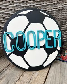 a soccer ball sitting on top of a wooden table next to a wicker basket