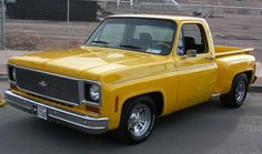 a yellow truck parked in a parking lot