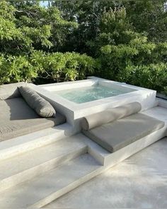 an outdoor jacuzzi tub sitting on top of concrete steps