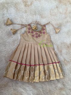 BUYER'S PLEASE LEAVE YOUR CONTACT NUMBER. It's necessary for shipping. Size: 3-6 months, 6-9months available. Please select required size. Baby girls beige(gold0 color pure silk knot frocks for cradle ceremony and celebrations. Maggam work with majenta stones and zardozi makes it more beautiful. It's a unique gift for your little one. We create each design with love and care. The dress is fully lined with soft cotton and the stitches are concealed. So your little princess feels comfortable in this frock. Chitralie by Lekha Meera proudly announcing the launch of our new kids ethnic wear collection. "Papa Ki Pari".... Papa ki pari showcases the timeless elegance of Indian traditional textiles with minute details. Handcrafted with soft silk, Banarasi brocade and fine handloom Kasavu and embel Cradle Ceremony, Kids Ethnic Wear, Maggam Work, Little Princess, Beige Color, Baby Dress, Floral Embroidery