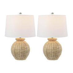 two wicker lamps with white shades on them