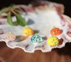 there are many small toy animals on the shell in front of each other and one is wearing a ring