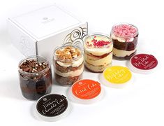 six different desserts in glass jars with labels on the bottom and one has a white box