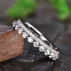 a close up view of a wedding ring on a piece of wood