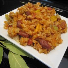 a white plate topped with rice and sausage