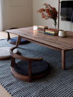 a wooden table sitting on top of a rug