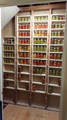 the shelves are filled with many different types of jars and sauces in each section