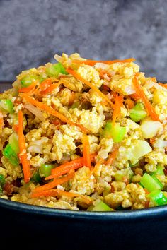 a bowl filled with rice, carrots and celery