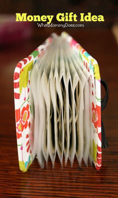 an open book sitting on top of a wooden table with the title money gift idea