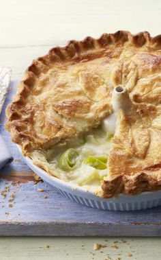 a pie sitting on top of a wooden cutting board