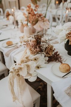 the table is set with flowers and other things to be used as decorations for an event