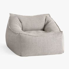 a grey bean bag chair sitting on top of a white floor