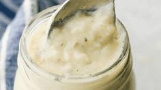 a spoon is sticking out of a jar filled with cream