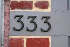 the number 533 is displayed on a brick wall