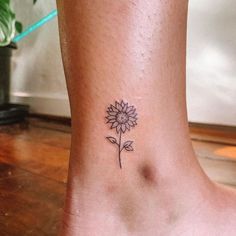 a small sunflower tattoo on the ankle