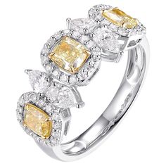 This luxurious ring is expertly crafted from 18-karat white gold and features an exquisite design adorned with fancy yellow diamonds and sparkling white diamonds. The fancy yellow diamonds, totaling 1.87 carats, are set in 18K white gold to accentuate their vibrant color, while the white diamonds provide a dazzling contrast. This elegant piece is perfect as a wedding gift or a special addition to any jewelry collection. Its sophisticated design and exceptional craftsmanship make it a timeless pi