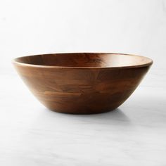 a wooden bowl sitting on top of a white counter