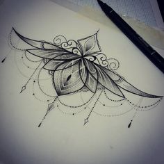 a drawing of a flower on paper next to a pen