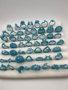 several pieces of blue plastic sitting on top of a white surface with various shapes and sizes