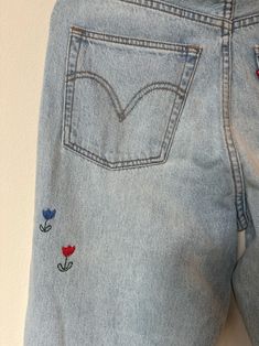 Hand Embroidered Levis - Etsy Trendy Medium Wash Jeans With Floral Embroidery, Vintage Pants With Floral Embroidery For Spring, Trendy Straight Leg Pants With Floral Embroidery, Vintage Floral Embroidered Pants For Spring, Denim Straight Leg Pants With Floral Embroidery, Straight Leg Denim Pants With Floral Embroidery, Wide Leg Denim Blue Jeans With Floral Embroidery, Vintage Floral Embroidered Jeans For Spring, Spring Floral Embroidered Straight Leg Jeans