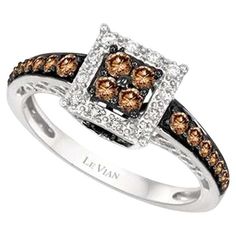 a ring with brown and white diamonds on it's sides, set in 18k white gold