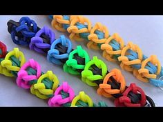 four different colors of rubber bracelets on a table