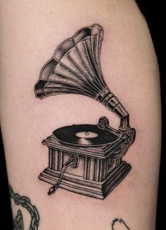 an old record player tattoo on the arm