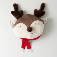 a stuffed reindeer head hanging on the wall