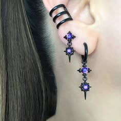 Our Classic Double North Star earrings are now available as a hoop.   Earrings are made of 316 Stainless steel, and set with Black ,Blue and  Purple  CZ. Hoops are perfect for both men and women.   Sold as Pair Total height: 40 mm Hoop Inner diameter: 10.5 mm Post Gauge: 22G (regular piercing) *RETURNS / REFUNDS * -If you would like to return you purchase , please contact us within 7 days of receiving your package and we will accept the return.Return will only be made to the product, and not the shipping cost.  -Buyer is  responsible for the return shipping costs . -All jewelry must be returned unworn and in their original condition . *LOST MAIL* Once the package is marked as DELIVERED by the post office, we are not responsible for misplaced or stolen packages. *MAIL THEFT* If parcel is st Gothic Star-shaped Party Jewelry, Punk Style Small Hoop Pierced Jewelry, Edgy Purple Jewelry For Gift, Edgy Purple Jewelry For Gifts, Edgy Purple Jewelry As Gift, Edgy Pierced Hoop Earrings As Gift, Gothic Dangle Hoop Earrings, Edgy Small Hoop Earrings As Gift, Edgy Hoop Piercings For Gift