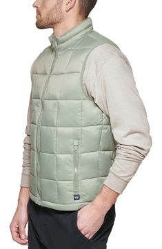 Windowpane stitching patterns turn this quilted puffer vest into a modern must-have accessory. Stand-up collar Sleeveless Front zip closure Dual front pockets Lined 100% recycled polyester Machine wash Imported Model stats: 6'1" height, 32" waist. Model is wearing size M Outdoor Puffer Vest Jacket Sleeveless, Fitted Quilted Nylon Vest, Casual Quilted Outerwear From Recycled Polyester, Casual Quilted Outerwear In Recycled Polyester, Solid Nylon Vest With Pockets, Nylon Vest With Pockets, Casual Nylon Vest With Padded Collar, Casual Sleeveless Puffer Jacket With Pockets, Casual Sleeveless Puffer Jacket