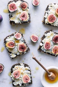 toasted bread topped with figs and cottage cheese next to a bowl of honey