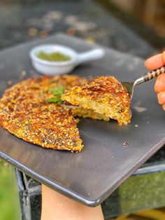 a person is holding a knife and cutting into a piece of food on a plate