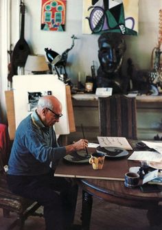 an older man sitting at a table in front of a plate