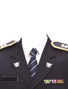 a man wearing a suit and tie with medals on his lapel, standing in front of a white background