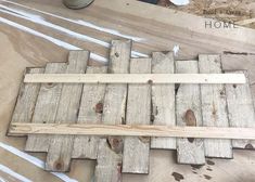 some wood planks are laying on the floor and being used as a wall decoration