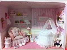 a doll's house with furniture and accessories in the room, including a baby crib