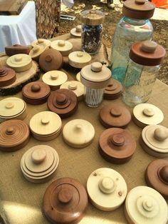 many wooden bowls and lids on a table