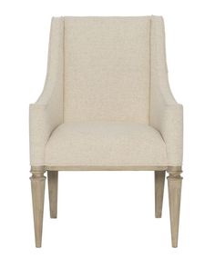 an upholstered beige chair with wooden legs