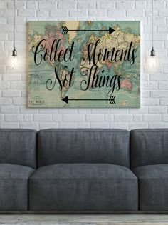 a couch in front of a white brick wall with the words collect moments not things on it