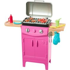 a pink toy stove with food on it