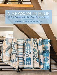 the cover of a quilt book, featuring blue and white quilts on a rack