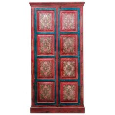 an old red and blue cabinet with ornate designs on the doors, isolated against a white background