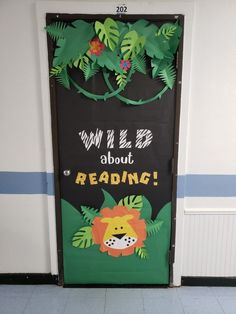 a door decorated with paper cutouts and jungle animals on it's side, which reads why i love about reading