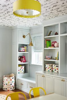 a child's playroom with toys and bookshelves