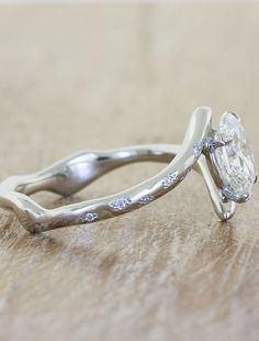 a close up of a diamond ring on a table