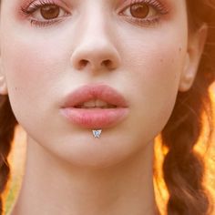 a close up of a woman wearing a nose ring